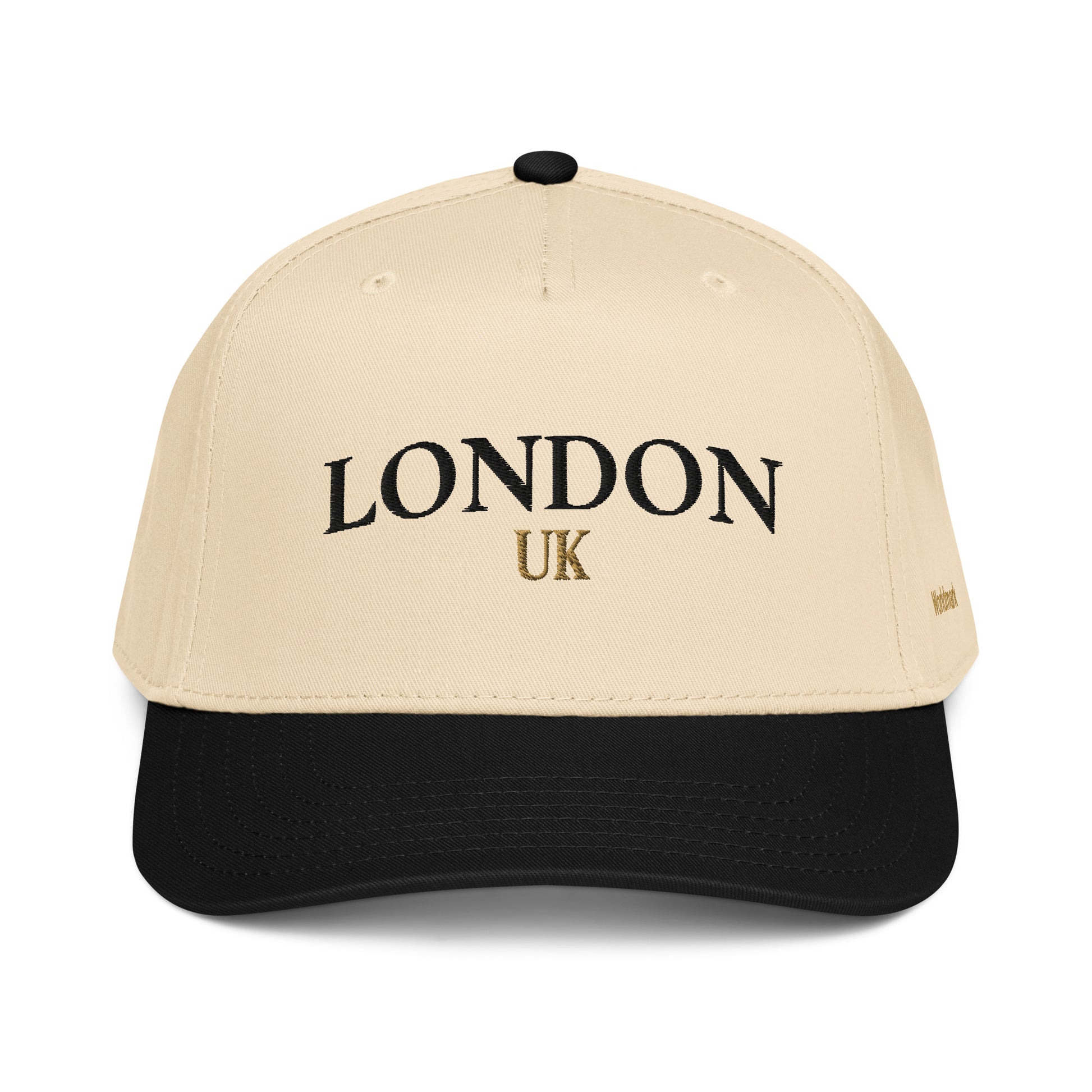 Two-tone cream and black London embroidered cap featuring gold UK accent and Worldmark logo — refined British minimal style.
