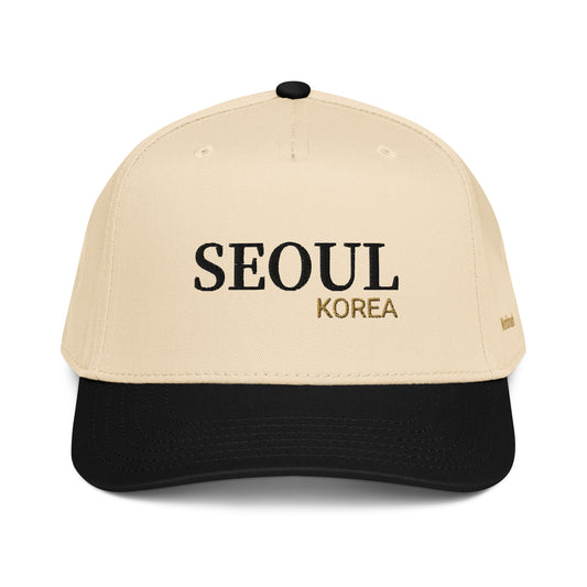Two-tone cream and black Seoul embroidered cap featuring gold “KOREA” text and Worldmark logo — modern Korean minimal style.