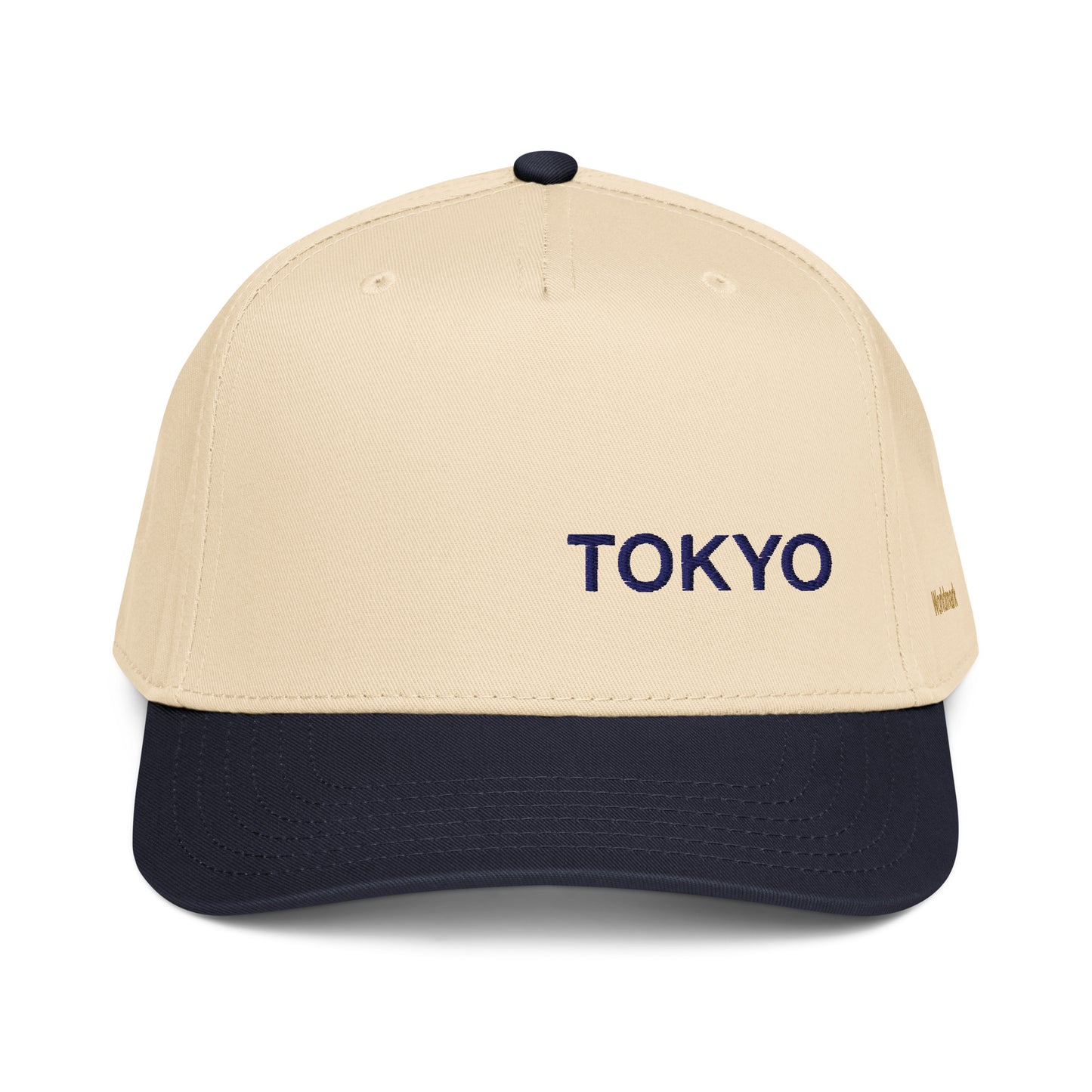 Two-tone cream and navy Tokyo embroidered cap featuring minimalist typography and gold Worldmark logo — modern Japanese design.
