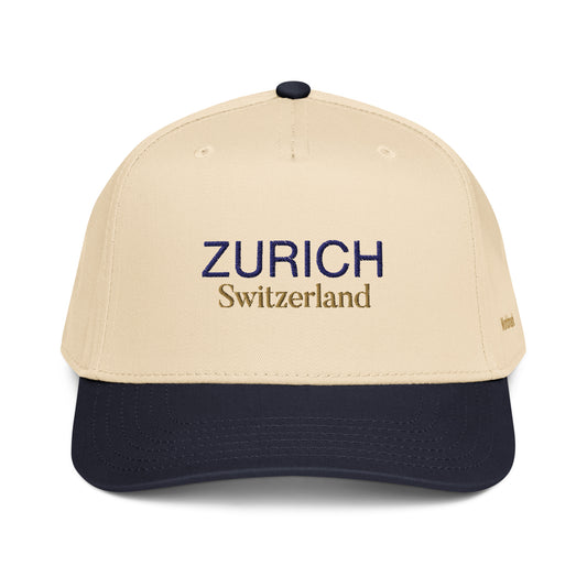 Two-tone cream and navy Zurich embroidered cap featuring gold “Switzerland” text and Worldmark logo — inspired by Swiss elegance and minimal European design.