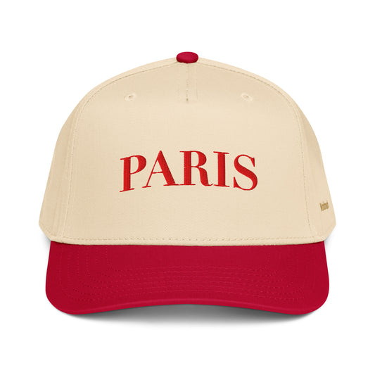 Two-tone cream and red Paris embroidered cap featuring minimalist serif typography and gold Worldmark logo — French chic style.